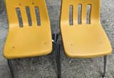 2 yellow hard plastic chairs